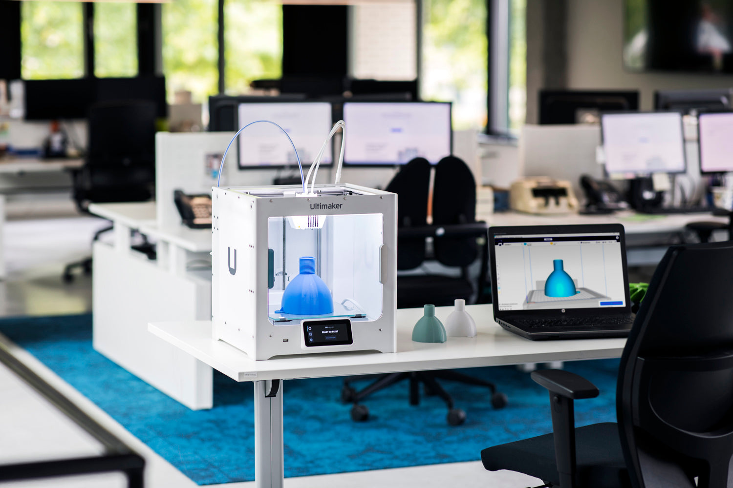 UltiMaker S3 on desktop next to laptop with cura open